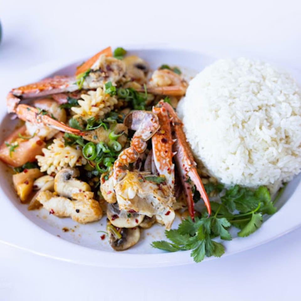 TG Thai Food's spicy seafood stir-fry with crab, squid, shrimp, mushrooms, and rice.